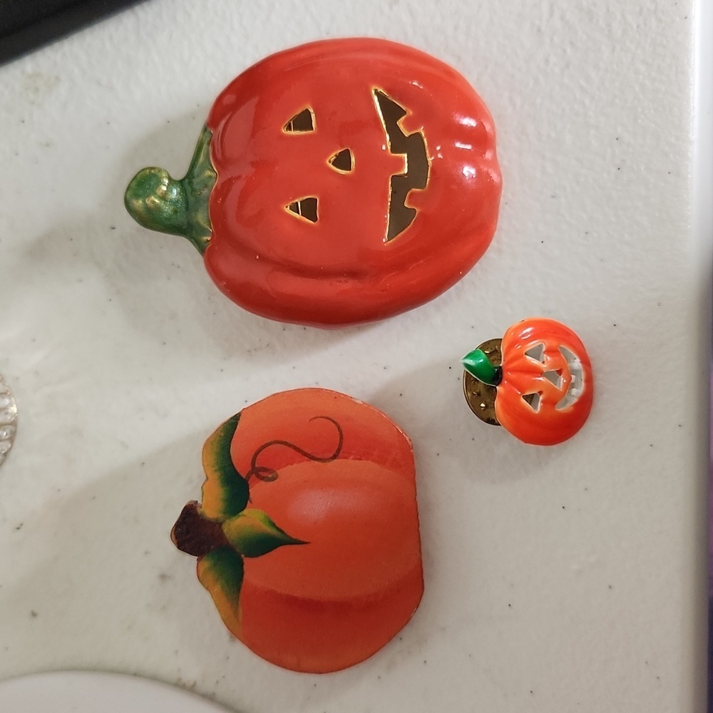 Three pumpkin brooches